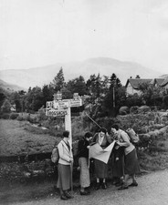 Four female hikers stop road