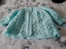 hand knitted matinee coat in blue