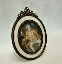 Regency ormolu framed miniature oval portrait of a gentleman with easel stand.