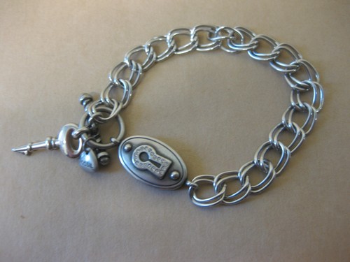 Fossil bracelet lock key - &, ~