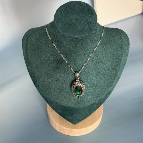 Green and silver locket - and,