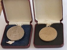 TWO "QUEEN ELIZABETH 11 ,COMMEMORATION LARGE COINS IM CASES.