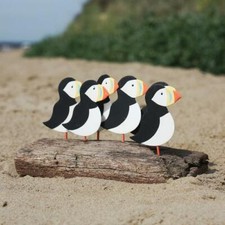 Flock of Puffins on Driftwood