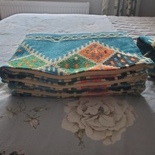 A  large Kilim floor cushion cover and armrest.