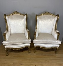 Early C20th Pair of carved and gilded French winged armchairs 