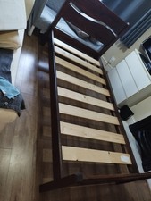 Single  solid wooden bed frame  in mahogany colour.
