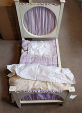Antique Upholstered Child's Doll Bed with matching bedding.