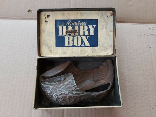 Old hinged tin clogs - tin, chocolate
