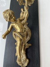 An Antique Brass Cherub French Or Italian /putto Candle Holder On A Backplate