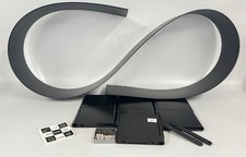 A KARTELL BOOKWORM WALL HUNG BOOK SHELF.