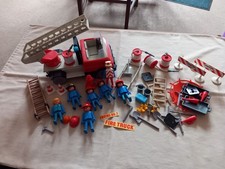Vintage 1975 Playmobil Fire Engine with figures and accessories.