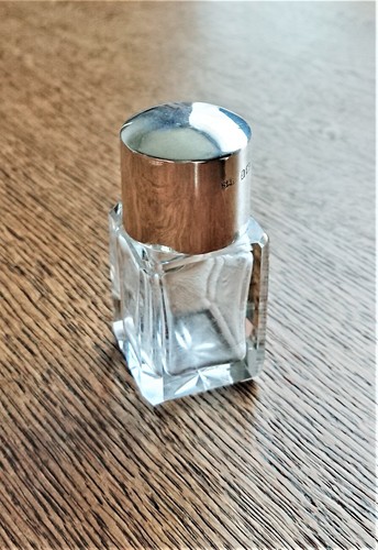 Silver capped perfume bottle - capped,