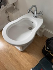 Traditional basin with tap and a bidet and traditional toilet