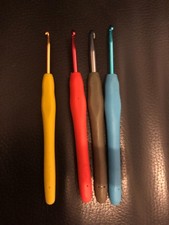 Set of four multicoloured ergonomic crochet hooks mixed sizes metal 14 cms L