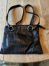 Gigi black real leather med/large shoulder bag with fancy strap fasteners. VGC