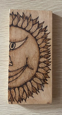pyrography art/suns face on a