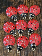 9 gold tone red enamel