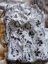 3-6 month baby grows with white and black designs.