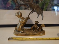 Brass dog with puppies under umbrella