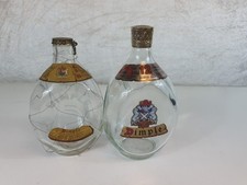 2 Vintage Dimple Logo Bottles-