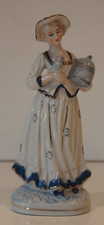 A LOVELY BLUE & WHITE LADY FIGURINE CARRYING A BIRD & A CAGE WITH GOLD GILDING.