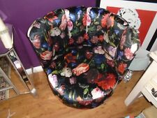 Revolving tub shape chair covered in floral velour fabric. Very stylish.