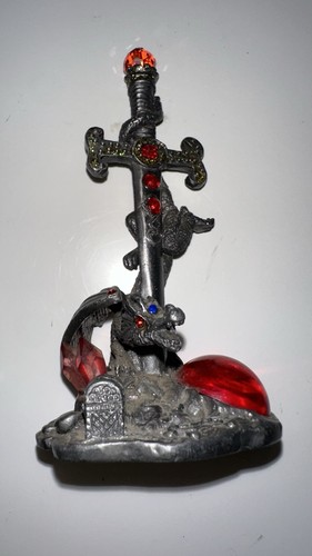 Pewter dragon wrapped around - around, a