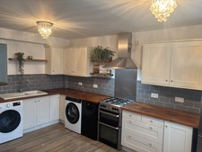 Shaker style used kitchen in matt cream with hardwood worktop