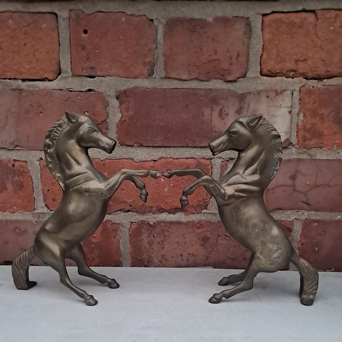 Pair old brass rearing - of,