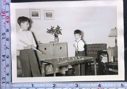 Two children shooting pool - two,