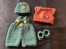 Hand knitted dolls clothes to