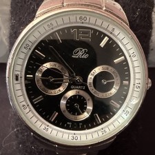 Rio Quartz men's analog watch with a black dial and a silver-toned metal band.