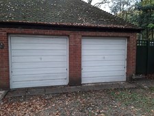 Two 7x7ft white manual Garador up and over garage doors in  workin order