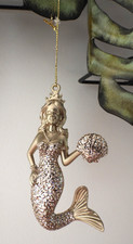 Silver tone mermaid holding shell christmas bauble