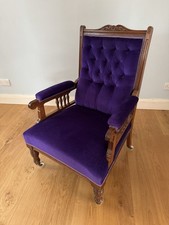 Antique arm chair upholstered In purple velvet