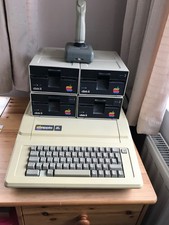 Apple IIe computer with four 5.25" disc drives and a Suncom games controller