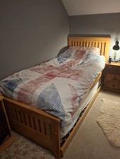 Solid oak single bed frame with pull-out bed. Excellent condition. 