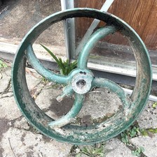 TWO VINTAGE CAST IRON MACHINE PULLY/FLYWHEELS
