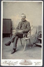 Seated man in studio - cabinet