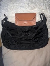 women  a purse and a hand bag