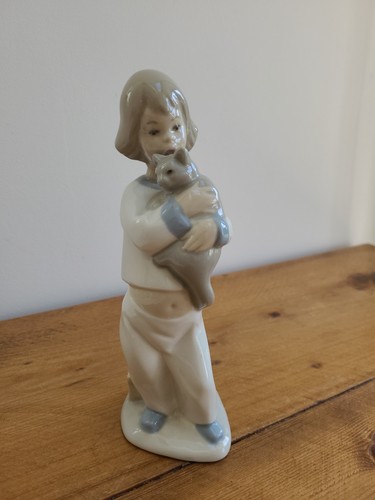 Child holding cat - child, figurine