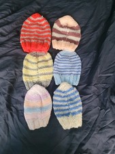 Selection Of Hand Knitted Baby Hats And Baby Boy Clothing