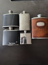 Hip flasks Assorted 5 Stainless Steel, 3 With Leather Jacket, 2 Branded Flasks.