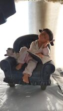 porcelain statue little girl reading on chair with puppy