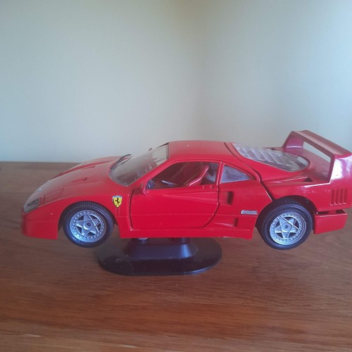 Red toy ferrari a stand - , on