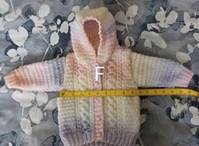 Baby girl's hand knitted cable