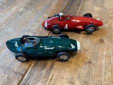 Two Scalextric 1960s style Formula 1 cars. A Vanwalll and a Maserati.
