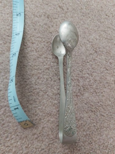 Sugar tongs possibly silver - possibly,