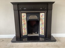 Cast iron fireplace with side tiles , stained wood surround, marble hearth