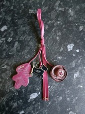 Radley burgundy leather and silver coloured dog, flower, leaf bag charm